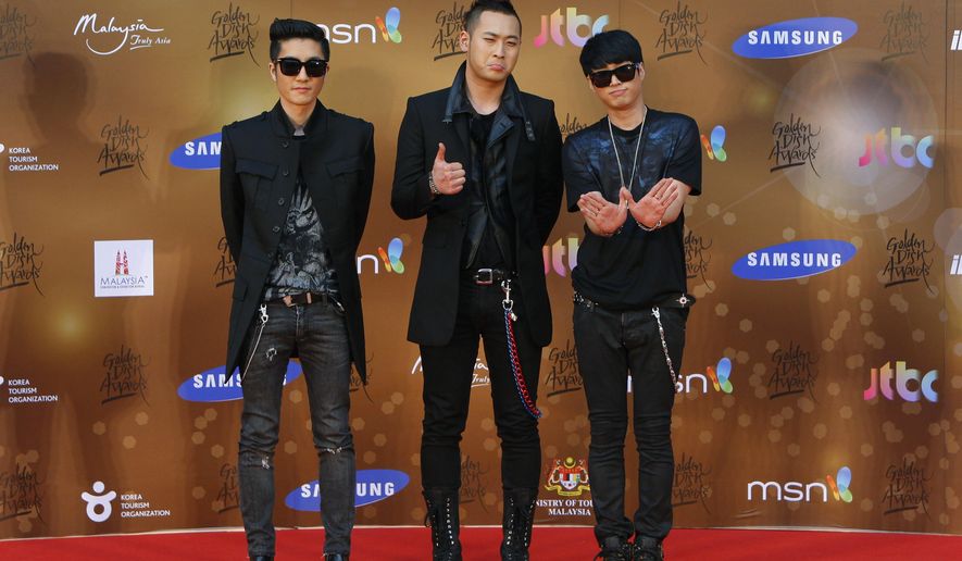 FILE - In this Jan. 16, 2013, file photo, South Korean alternative hip-hop group Epik High poses for photographers as they arrive on the red carpet ahead of the 27th Golden Disk Awards at Sepang International Circuit in Sepang, Malaysia. Popular South Korean hip-hop trio Epik High was working on a song called “End of the World” before the pandemic hit in 2020. Now, the band&#39;s frontman Tablo says, “I wish that this song is not relevant.” (AP Photo/Lai Seng Sin, File)