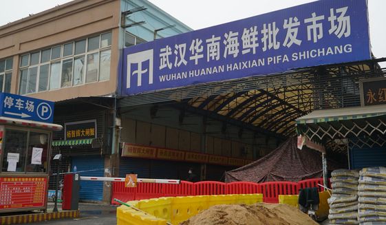 FILE - In this Jan. 21, 2020, file photo, the Wuhan Huanan Wholesale Seafood Market, where a number of people related to the market fell ill with a virus, sits closed in Wuhan in central China&#39;s Hubei province. The Chinese city of Wuhan is looking back on a year since it was placed under a 76-day lockdown beginning Jan. 23, 2020. (AP Photo/Dake Kang, File)