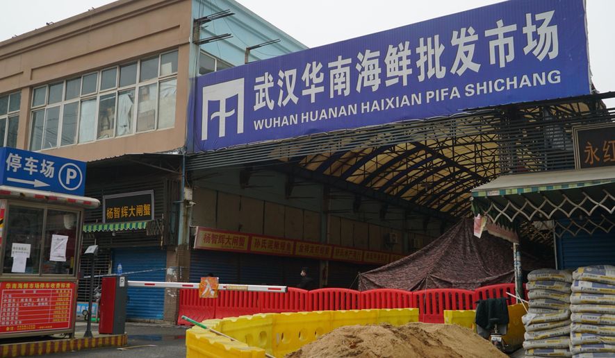FILE - In this Jan. 21, 2020, file photo, the Wuhan Huanan Wholesale Seafood Market, where a number of people related to the market fell ill with a virus, sits closed in Wuhan in central China&#x27;s Hubei province. The Chinese city of Wuhan is looking back on a year since it was placed under a 76-day lockdown beginning Jan. 23, 2020. (AP Photo/Dake Kang, File)