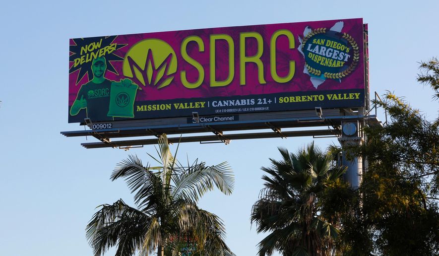 FILE - In this Jan. 13, 2020, file photo, a billboard in San Diego advertises a cannabis dispensary. The state Bureau of Cannabis Control on Thursday said billboard companies must stop selling space for cannabis marketing and take down existing ads on roads that cross state borders. The new regulation covers about three dozen state and interstate routes. (Nelvin C. Cepeda/The San Diego Union-Tribune via AP, File)