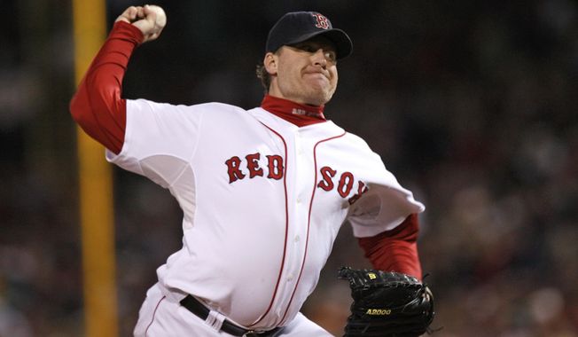 FILE - In this Oct. 25, 2007, file photo, Boston Red Sox&#x27;s Curt Schilling pitches against the Colorado Rockies in Game 2 of the baseball World Series at Fenway Park in Boston. Like many baseball writers, C. Trent Rosecrans viewed the Hall of Fame vote as a labor of love. The results of the 2021 vote will be announced Tuesday, Jan. 26, 2021, and Rosecrans was not alone in finding the task particularly agonizing this time around. With Schilling&#x27;s candidacy now front and center — and Barry Bonds and Roger Clemens still on the ballot as well — voters have had to consider how much a player’s off-field behavior should affect his Hall of Fame chances. (AP Photo/Kathy Willens, File)