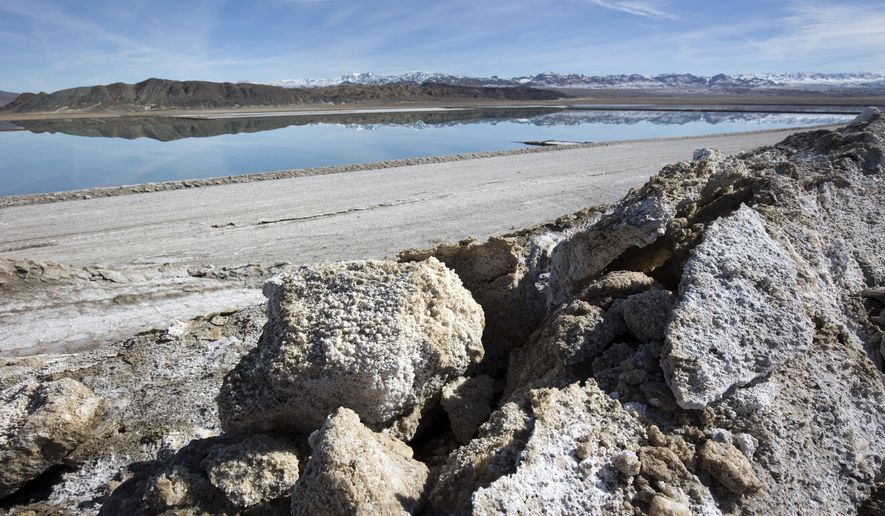 FILE - In this Jan. 30, 2017, file photo, waste salt, foreground, is shown near an evaporation pond at the Silver Peak lithium mine near Tonopah, Nev.  The Trump administration granted final approval for a proposed northern Nevada lithium mine, one of several eleventh-hour moves made by the Department of Interior to greenlight mining and energy projects. Unlike some other approvals, which are likely to be revoked, President Biden has voiced support for lithium mining as part of his clean energy plans.  (Steve Marcus/Las Vegas Sun via AP, File)