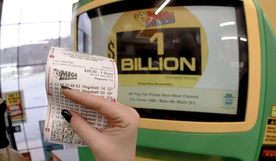 A patron, who did not want to give her name, shows the ticket she had just bought for the Mega Millions lottery drawing at the lottery ticket vending kiosk in a Smoker Friendly store, Friday, Jan. 22, 2021, in Cranberry Township, Pa. The jackpot for the Mega Millions lottery game has grown to $1 billion ahead of Friday night&#39;s drawing after more than four months without a winner. (AP Photo/Keith Srakocic)