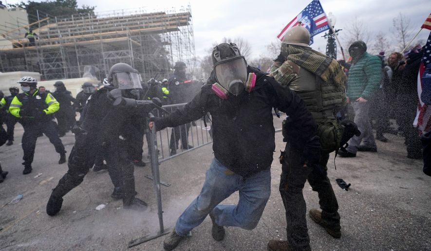Trump supporters try to break through a police barrier, Wednesday, Jan. 6, 2021, at the Capitol in Washington. As Congress prepares to affirm President-elect Joe Biden&#39;s victory, thousands of people have gathered to show their support for President Donald Trump and his claims of election fraud. (AP Photo/Julio Cortez) **FILE**