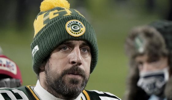 Green Bay Packers quarterback Aaron Rodgers (12) walks off the field after the NFC championship NFL football game against the Tampa Bay Buccaneers in Green Bay, Wis., Sunday, Jan. 24, 2021. The Buccaneers defeated the Packers 31-26 to advance to the Super Bowl. (AP Photo/Morry Gash)