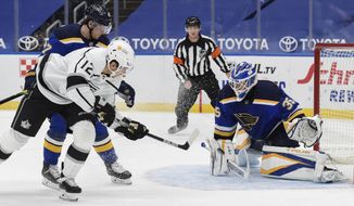 St. Louis Blues&#39; Torey Krug (47) and St. Louis Blues&#39; Ville Husso (35) defends the net against Los Angeles Kings&#39; Trevor Moore (12) during the second period of an NHL hockey game Sunday, Jan. 24, 2021, in St. Louis. (AP Photo/Joe Puetz)