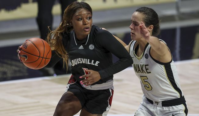 Louisville guard Dana Evans, left, drives around Wake Forest guard Gina Conti (5) in the first quarter of an NCAA women&#x27;s college basketball game in Winston-Salem, N.C., Sunday, Jan. 24, 2021. (AP Photo/Nell Redmond)