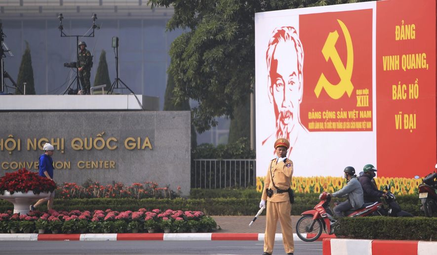 A police officer directs traffic in front of the National Convention Center in Hanoi, Vietnam, Saturday, Jan. 23, 2021. Almost 1,600 leading members of Vietnam&#x27;s Communist Party on Tuesday begin a meeting to set policy for the next five years and select the group&#x27;s senior members to steer the nation. (AP Photo/Hau Dinh)