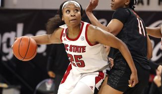 North Carolina State&#39;s Kayla Jones (25) drives around Virginia Tech&#39;s D&#39;asia Gregg (11) during the first half of an NCAA college basketball game, Sunday, Jan. 24, 2021 in Raleigh, N.C. (Ethan Hyman/The News &amp;amp; Observer via AP)