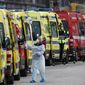 More than a dozen ambulances queue waiting to hand over their COVID-19 patients to medics at the Santa Maria hospital in Lisbon, Friday, Jan. 22, 2021.  Portugal&#39;s COVID-19 surge is continuing unabated, with a new record of daily deaths, hospitalizations and patients in intensive care. (AP Photo/Armando Franca)