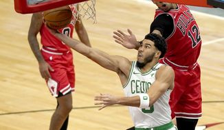 Boston Celtics&#39; Jayson Tatum scores on a reverse layup during the first half of an NBA basketball game against the Chicago Bulls, Monday, Jan. 25, 2021, in Chicago. (AP Photo/Charles Rex Arbogast)