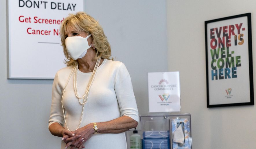 First lady Jill Biden smiles as she tours Whitman-Walker Health, Friday, Jan. 22, 2021, in Washington. (AP Photo/Jacquelyn Martin, Pool)