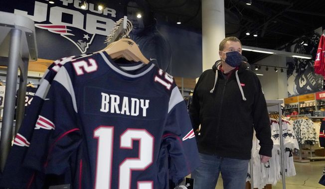Football fan Brian Pope browses for Tom Brady jerseys in the pro shop at Gillette Stadium, Monday, Jan. 25, 2021, in Foxborough, Mass. Tom Brady is going to the Super Bowl for the 10th time, and New England Patriots football fans are cheering for him -- just like before. (AP Photo/Elise Amendola)