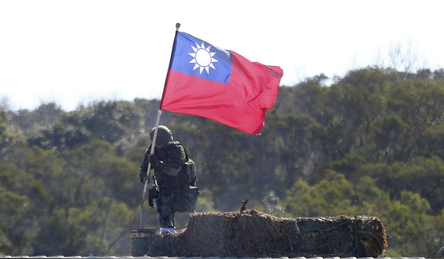 A soldier holds a Taiwan national flag during a military exercise in Hsinchu County, northern Taiwan, Tuesday, Jan. 19, 2021. (AP Photo/Chiang Ying-ying)  **FILE**