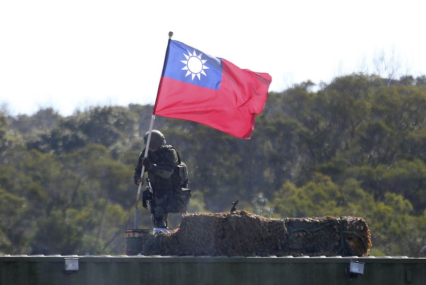 A soldier holds a Taiwan national flag during a military exercise in Hsinchu County, northern Taiwan, Tuesday, Jan. 19, 2021. (AP Photo/Chiang Ying-ying)  **FILE**