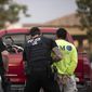 In this July 8, 2019, photo, U.S. Immigration and Customs Enforcement (ICE) officers detain a man during an operation in Escondido, Calif. (AP Photo/Gregory Bull) ** FILE **