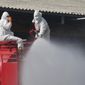 Workers spray disinfectant as a precaution against the coronavirus at a shrimp market in Samut Sakhon, Thailand, Monday, Jan. 25, 2021. Thailand on Monday registered a new daily high of over 900 confirmed new cases of the coronavirus at the province near the capital Bangkok, where a major outbreak occurred in December. (AP Photo)