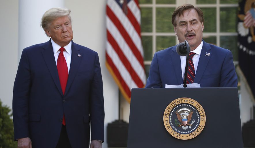 In this March 30, 2020, photo, My Pillow CEO Mike Lindell speaks as President Donald Trump listens during a briefing about the coronavirus in the Rose Garden of the White House, in Washington. (AP Photo/Alex Brandon) **FILE**