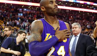FILE - In this Dec. 30, 2015, file photo, Los Angeles Lakers&#39; Kobe Bryant touches his chest as he walks off the court in Boston after the Lakers&#39; 112-104 win over the Boston Celtics in an NBA basketball game. Kobe Bryant&#39;s legacy may be stronger than ever. Tuesday, Jan. 26, 2021, marks the anniversary of the crash that took the lives of Bryant, his daughter Gianna and seven other people. (AP Photo/Winslow Townson, File)