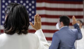 In this July 2, 2020, file photo, people take the oath of citizenship during a naturalization ceremony at U.S. Citizenship and Immigration Service&#39;s Field Office in New York. (AP Photo/Frank Franklin II, File)