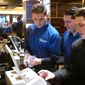 This Oct. 25, 2018 photo, employees at the sports book at the Tropicana casino in Atlantic City N.J. count money moments before it opened. Gambling companies in the U.S. are increasingly bringing different forms of gambling together, including sports betting, casino gambling, internet gambling and daily fantasy sports, and partnering with media companies as they seek to increase revenue. (AP Photo/Wayne Parry)