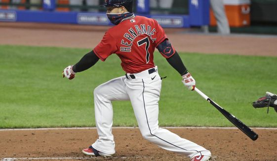 FILE - Cleveland Indians&#x27; Cesar Hernandez watches his ball after hitting an RBI-single in the fifth inning in a baseball game against the Cincinnati Reds in Cleveland, in this Wednesday, Aug. 5, 2020, file photo. Free agent second baseman César Hernández has agreed to return to the Cleveland Indians on a 1-year contract, a person familiar with the deal told the Associated Press on Tuesday, Jan. 26, 2021. (AP Photo/Tony Dejak, File)