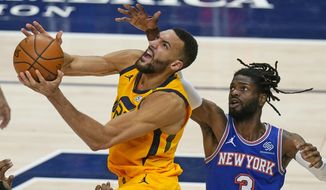 Utah Jazz center Rudy Gobert, left, lays the ball up as New York Knicks center Nerlens Noel (3) defends in the second half during an NBA basketball game Tuesday, Jan. 26, 2021, in Salt Lake City. (AP Photo/Rick Bowmer)