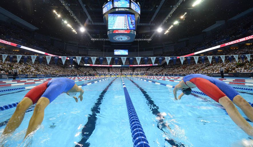 FILE - In this July 1, 2016, file photo, Elizabeth Beisel, left, and Missy Franklin start the women&#x27;s 200-meter backstroke semifinal at the U.S. Olympic swimming trials in Omaha, Neb. The U.S. Olympic swimming trials will be split into two meets, a radical change that is designed to provide safer conditions in the midst of the coronavirus pandemic. USA Swimming announced Tuesday, Jan. 26, 2021, that a Wave I meet, comprised of lower-ranked swimmers qualifying for the trials, will be held on June 4-7. The top finishers will advance to the main Wave II meet on June 13-20 to determine who represents the U.S at the Tokyo Games. (AP Photo/Mark J. Terrill, File)