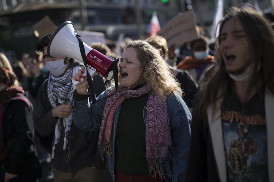 Students chant slogans during a demonstration in Marseille, southern France, Tuesday Jan. 26, 2021. Teachers and university students marched together in protests or went on strike Tuesday around France to demand more government support amid the pandemic. (AP Photo/Daniel Cole)