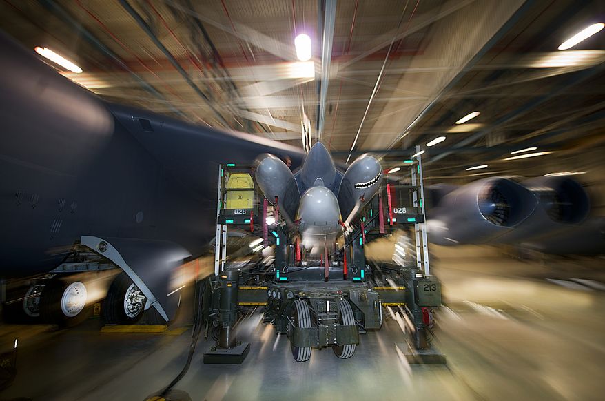 5th Aircraft Maintenance Squadron load crews load a AGM-86B air-cruise launch missile trainer onto a B-52H Stratofortess at Minot Air Force Base, N.D., Feb. 26, 2014. As part of Air Force Global Strike Command, load crews work endlessly to preserve our nation's security by providing combat-ready forces for nuclear deterrence and global strike operations. (U.S. Air Force photo/Tech. Sgt. Aaron D. Allmon II)