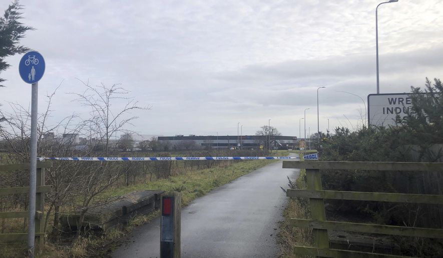 A police cordon at Wrexham Industrial Estate near the British pharmaceutical manufacturing company Wockhardt in Wrexham, north Wales, Wednesday Jan. 27, 2021. Wockhardt UK, an arm of the Mumbai-based pharmaceutical company that is producing the Oxford-AstraZeneca vaccine in north Wales, said it notified authorities after receiving a suspect package on Wednesday morning. (Eleanor Barlow/PA via AP)