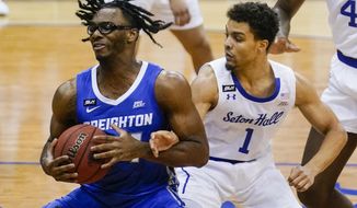Creighton&#39;s Denzel Mahoney, left, spins away from Seton Hall&#39;s Bryce Aiken during the first half of an NCAA college basketball game Wednesday, Jan. 27, 2021, in Newark, N.J. (AP Photo/Frank Franklin II)