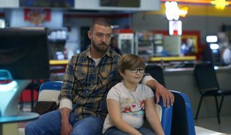 This image released by Apple shows Justin Timberlake, left, and Ryder Allen in a scene from “Palmer.” (Apple via AP)