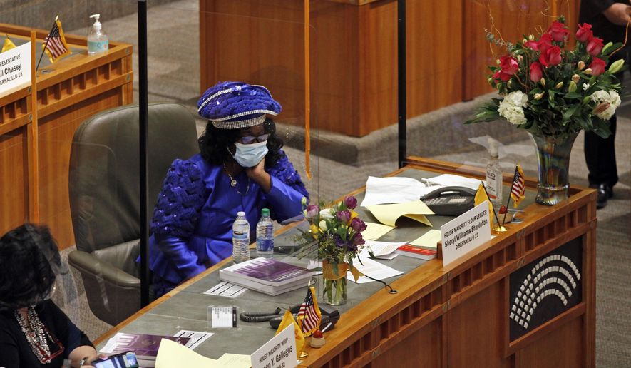 House Majority Leader Sheryl Williams Stapleton sits at her desk during the opening day of the legislative session on Tuesday, Jan. 19, 2021, in Santa Fe, New Mexico. Stapleton later introduced a bill that would outlaw hair and head covering discrimination in schools and workplaces. (AP Photo/Cedar Attanasio)