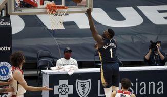 New Orleans Pelicans forward Zion Williamson (1) shoots over Washington Wizards guard Raul Neto (19) in the first quarter of an NBA basketball game in New Orleans, Wednesday, Jan. 27, 2021. (AP Photo/Derick Hingle)