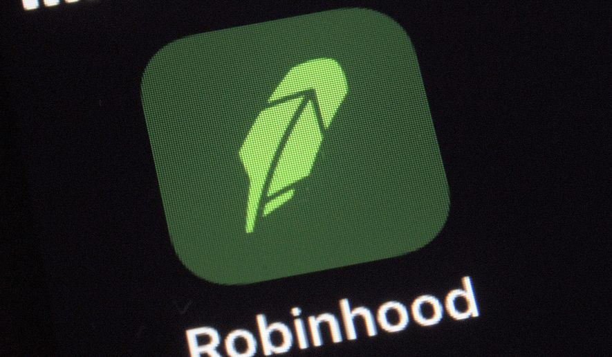 This  Dec. 17, 2020 file photo shows the logo for the Robinhood app on a smartphone in New York.  The online trading platform Robinhood is moving to restrict trading in GameStop and other stocks that have soared recently due to rabid buying by smaller investors.    (AP Photo/Patrick Sison)  **FILE**