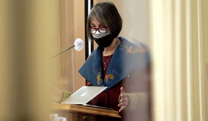 State Sen. Nancy Skinner, D-Berkeley, chair of the Senate Budget Committee, is seen between plexiglass as she urges lawmakers to approve a measure to provide eviction protections for renters at the Capitol in Sacramento, Calif., Thursday, Jan. 28, 2021. Both houses of the Legislature approved the bill to use $2.6 billion in federal stimulus money to pay off up to 80% of some tenants's unpaid rent but only if landlords agree to forgive the rest of their debt. The bills now go to Gov. Gavin Newsom who is expected to sign them into law. (AP Photo/Rich Pedroncelli)
