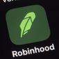 FILE - This  Dec. 17, 2020 file photo shows the logo for the Robinhood app on a smartphone in New York.  The online trading platform Robinhood is moving to restrict trading in GameStop and other stocks that have soared recently due to rabid buying by smaller investors.    (AP Photo/Patrick Sison)