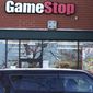 A vehicle passes in front of a GameStop store in Vernon Hills, Ill., Thursday, Jan. 28, 2021. The online trading platform Robinhood is moving to restrict trading in GameStop and other stocks that have soared recently due to rabid buying by smaller investors. GameStop stock has rocketed from below $20 earlier this month to close around $350 Wednesday as a volunteer army of investors on social media challenged big institutions who had placed market bets that the stock would fall. (AP Photo/Nam Y. Huh)