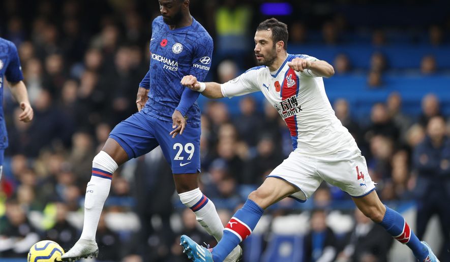 FILE - In this Saturday, Nov. 9, 2019 filer, Crystal Palace&#39;s Luka Milivojevic, right, challenges Chelsea&#39;s Fikayo Tomori during their English Premier League soccer match between Chelsea and Crystal Palace at Stamford Bridge stadium in London. Fikayo Tomori was loaned from Chelsea to AC Milan on Friday through the end of the season -- giving the Rossoneri an added option in defense in their bid to win Serie A. (AP Photo/Alastair Grant, File)