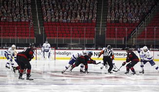 The Carolina Hurricanes take the opening faceoff against the Tampa Bay Lightning in an NHL hockey game in Raleigh, N.C., Thursday, Jan. 28, 2021. (AP Photo/Karl B DeBlaker)