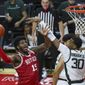 Rutgers center Myles Johnson (15) shoots as he is defended by Michigan State forward Marcus Bingham Jr. (30) during the first half of an NCAA college basketball game against Rutgers, Thursday, Jan. 28, 2021, in Piscataway, N.J. (Andrew Mills/NJ Advance Media via AP)