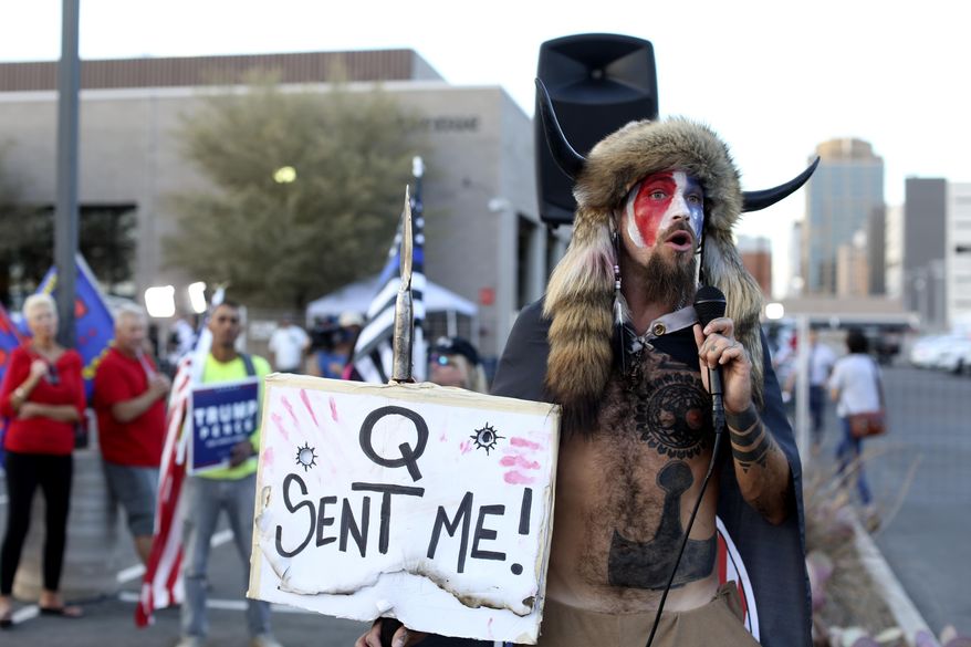 In this Nov. 5, 2020, photo, Jacob Anthony Chansley, who also goes by the name Jake Angeli, a Qanon believer speaks to a crowd of President Donald Trump supporters outside of the Maricopa County Recorder&#39;s Office where votes in the general election are being counted, in Phoenix. Some followers of the QAnon conspiracy theory are now turning to online support groups and even therapy to help them move on, now that it&#39;s clear Trump&#39;s presidency is over. (AP Photo/Dario Lopez-Mills) **FILE**