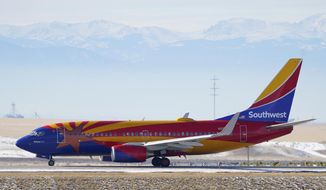 FILE - In this Dec. 31, 2020 file photo, a Southwest Airlines jetliner taxis down a runway for takeoff from Denver International Airport in Denver.  Southwest said Thursday, Jan. 28, 2021, that it lost $3.1 billion last year, its first full-year loss since 1972.  (AP Photo/David Zalubowski, File)