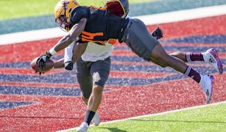 National Team wide receiver Frank Darby of Arizona State (84) leaps for a touchdown against National Team defensive back Camryn Bynum of California (24) during practice for the NCAA Senior Bowl college football game in Mobile, Ala., Thursday, Jan. 28, 2021. (AP Photo/Matthew Hinton)