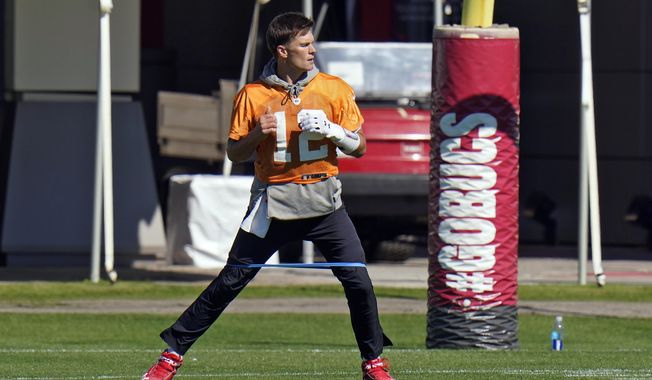 Tampa Bay Buccaneers quarterback Tom Brady (12) runs with an elastic band around his legs during an NFL football workout Thursday, Jan. 28, 2021, in Tampa, Fla. The Buccaneers play the Kansas City Chiefs in Super Bowl LV on Feb. 7. (AP Photo/Chris O&#x27;Meara)