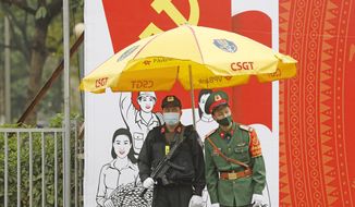 Vietnamese policemen wearing face masks stand guard outside the National Convention Center in Hanoi, Vietnam, Tuesday, Jan. 26, 2021. Vietnam&#39;s ruling Communist Party began a crucial week-long meeting in the capital Hanoi to set the nation&#39;s path for the next five years and appoint the country&#39;s top leaders. (AP Photo/Minh Hoang)