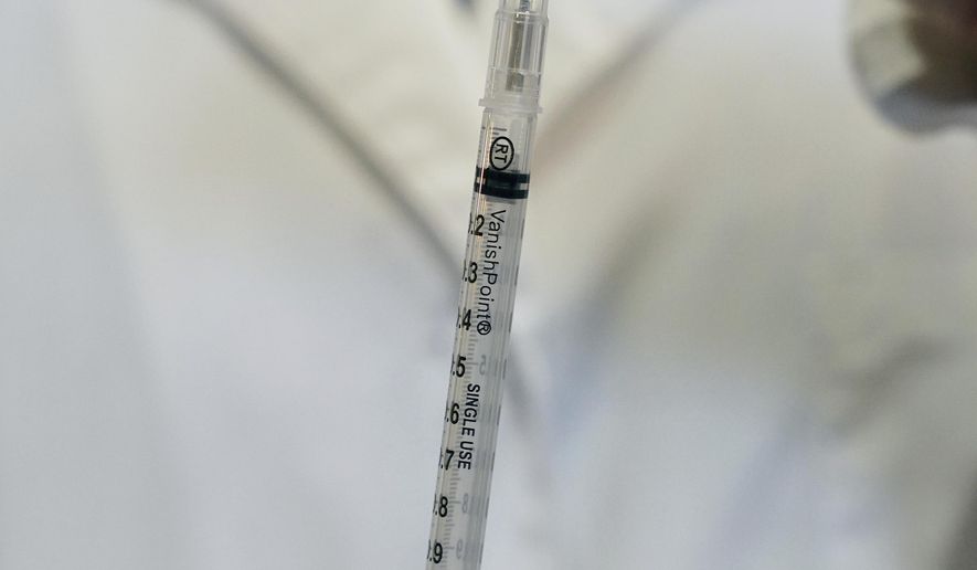 Clinical lead Jeanne Schumache held up a VanishPoint syringe that allows them to get an extra dose of the COVID-19 vaccine as she was preparing them to be administered to people with appointments Thursday, jan. 28, 2021 at the Earle Brown Heritage Center in Brooklyn Center. (Anthony Souffle/Star Tribune via AP)