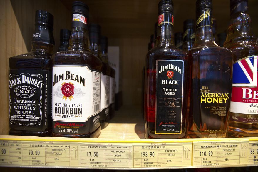 In this July 7, 2018 file photo whiskeys distilled and bottled in the U.S. are displayed for sale in a grocery store in Beijing. (AP Photo/Mark Schiefelbein, file) **FILE**