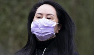 Chief Financial Officer of Huawei, Meng Wanzhou leaves her home in Vancouver, British Columbia, to go to the British Columbia Supreme Court on Friday, Jan. 29, 2021. (Jonathan Hayward/The Canadian Press via AP)